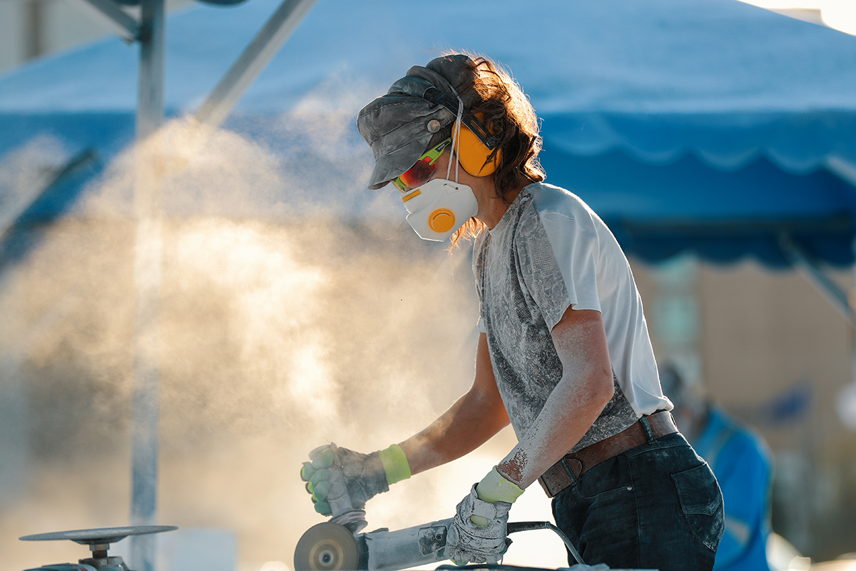 Artist sculpting marble