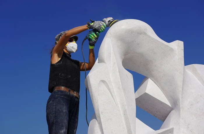 Artist at work sculpting marble