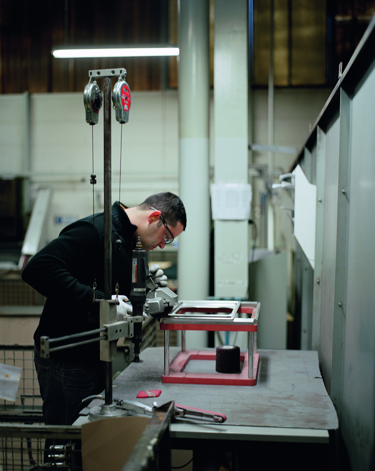 factory worker bending metal