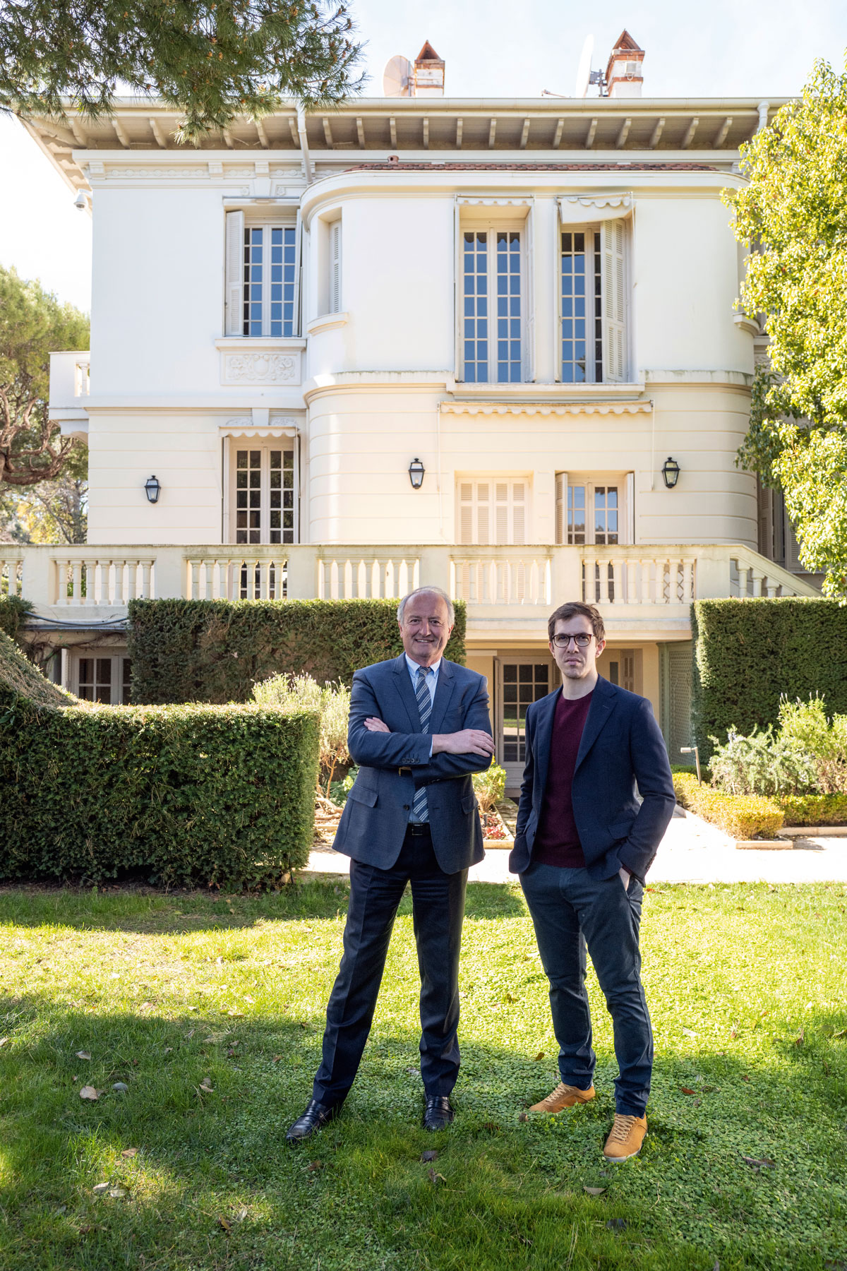 Two men standing in front of villa