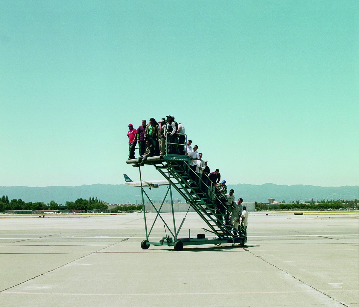 people standing on plane steps