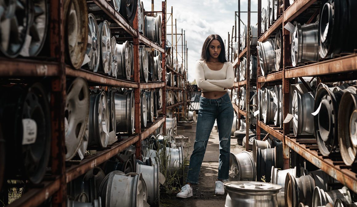 Woman standing amongst tyres