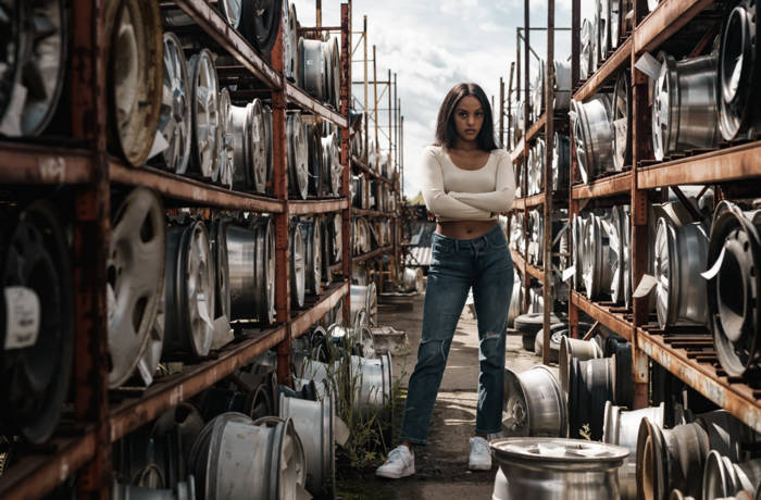 Woman standing amongst tyres