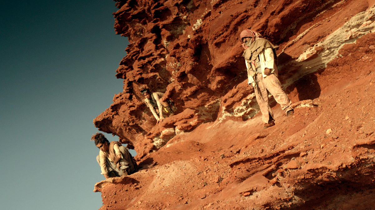 men on the edge of a rocky cliff