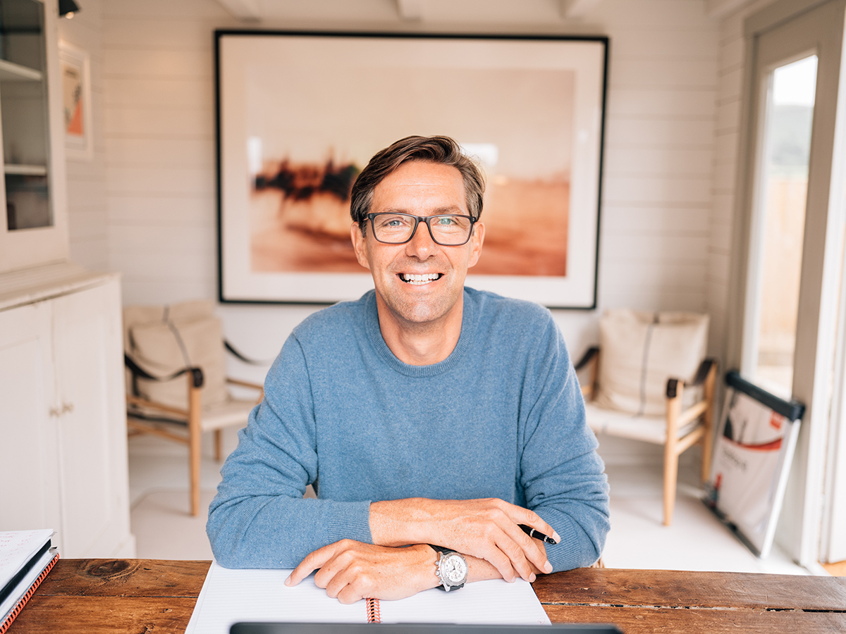 man in glasses at his desk