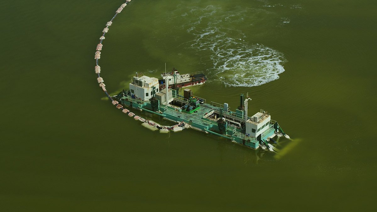 industrial boat on a green lake