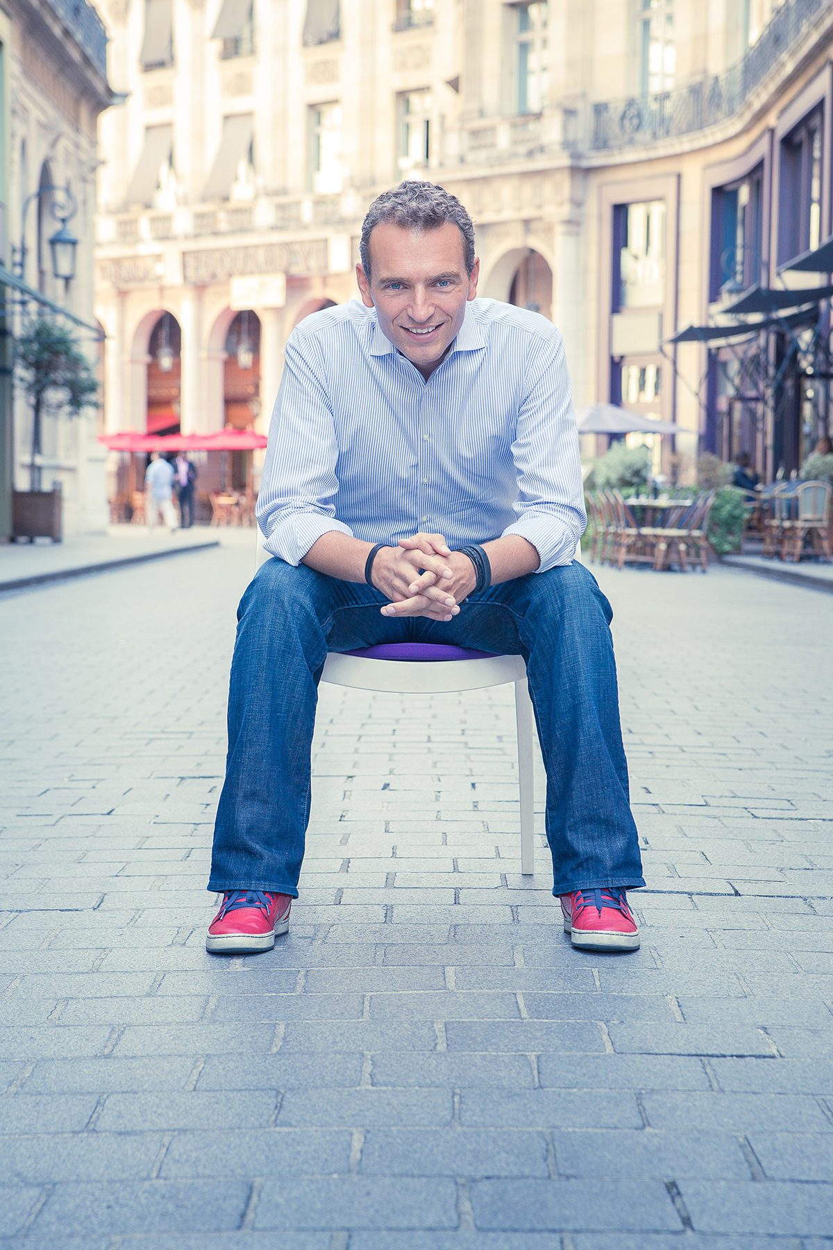 Man posing on chair on paris streets