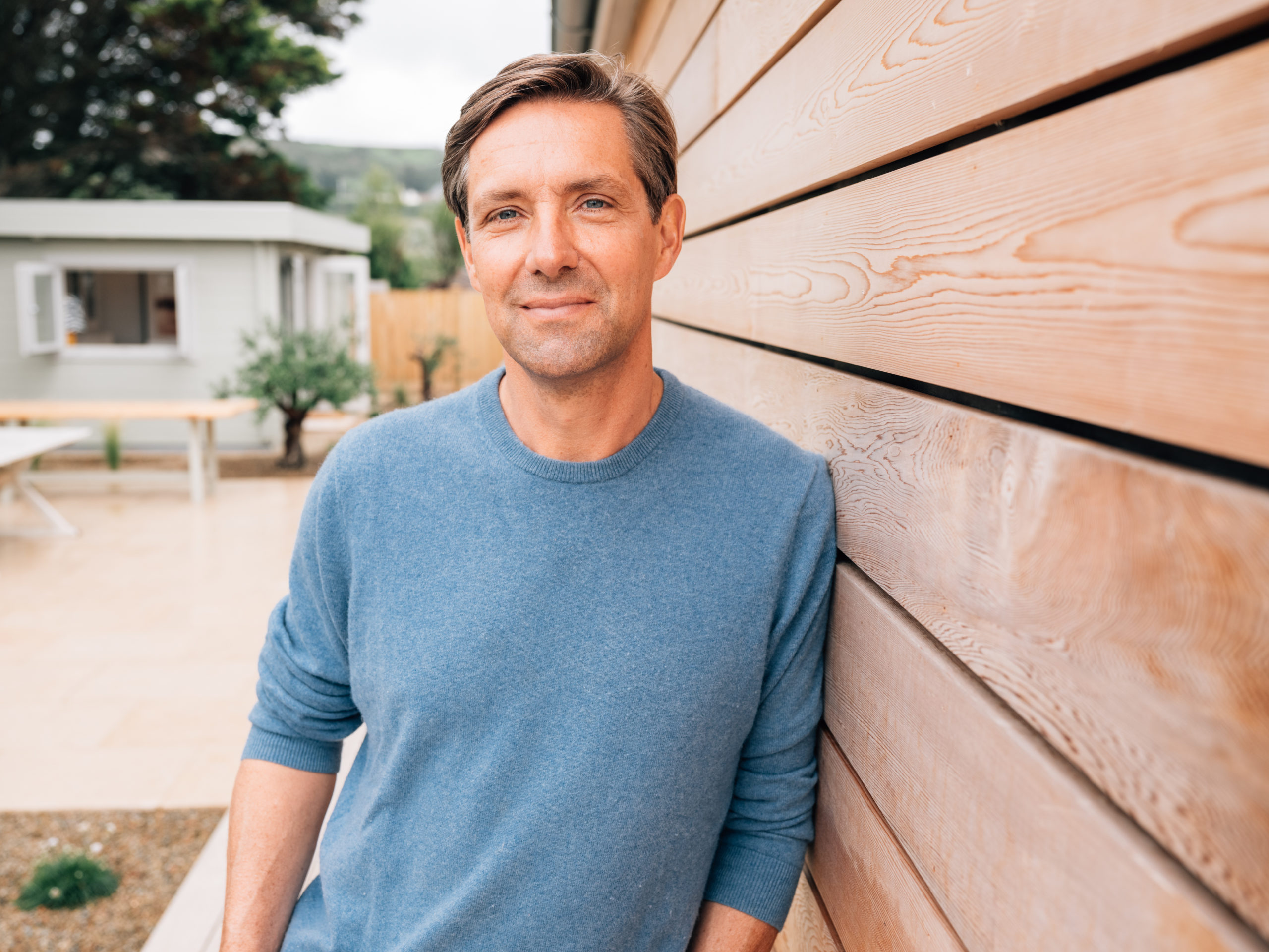 man leaning against wall