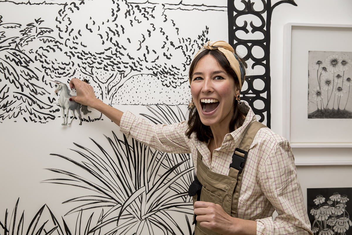 women painting mural