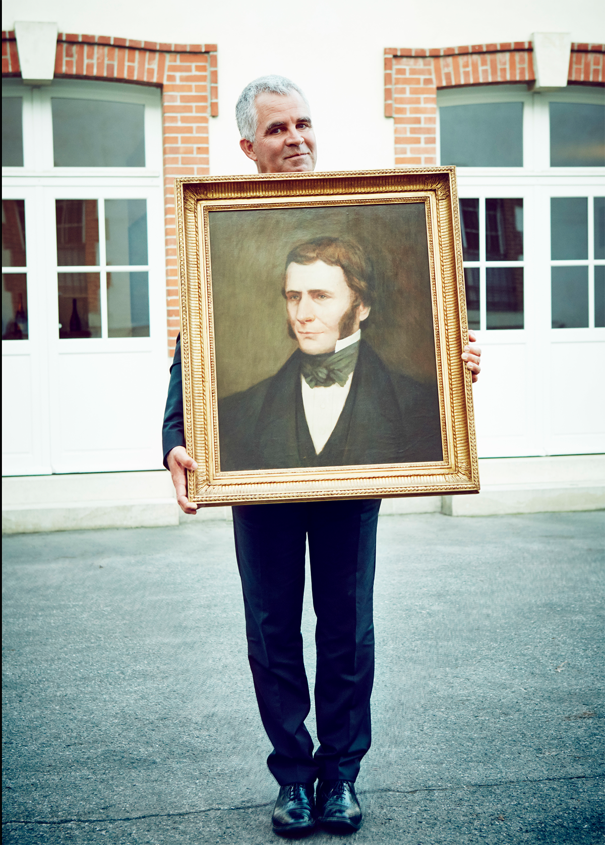 man holding family portrait