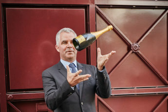 man throwing champagne botle