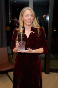 woman holding bottle of whiskey