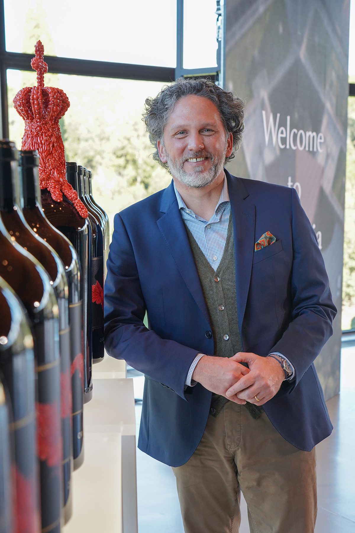 man standing by wine bottles