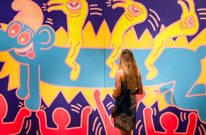 woman looking at colourful artwork