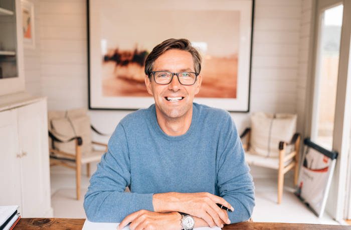 man sitting at a desk wearing glasses