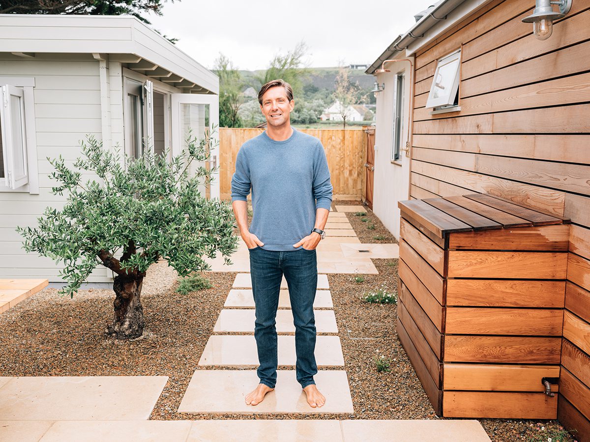 man standing barefoot on a pathway