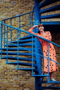 woman standing on blue staircase