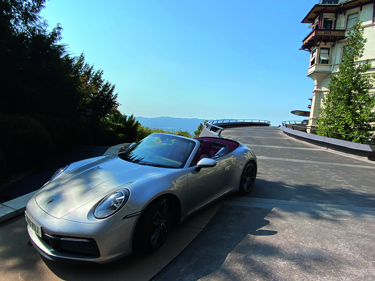 Car on a road above a lake