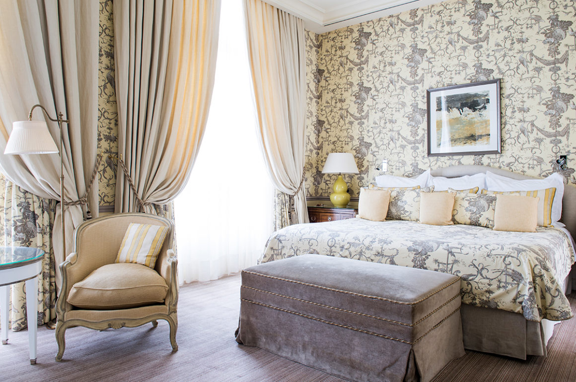 hotel bedroom with plush furnishings