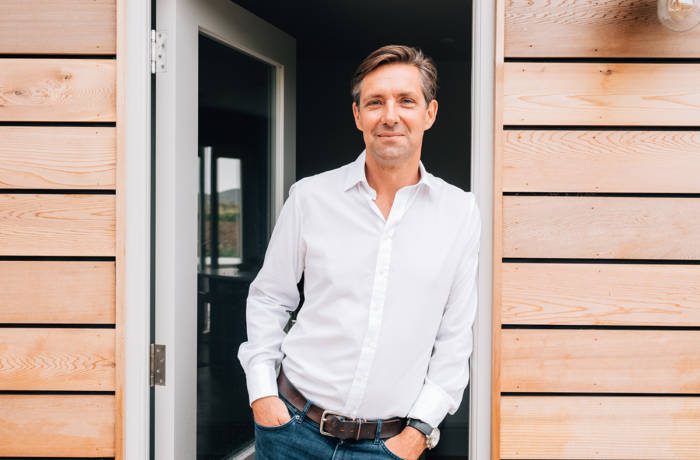 man leaning against door frame