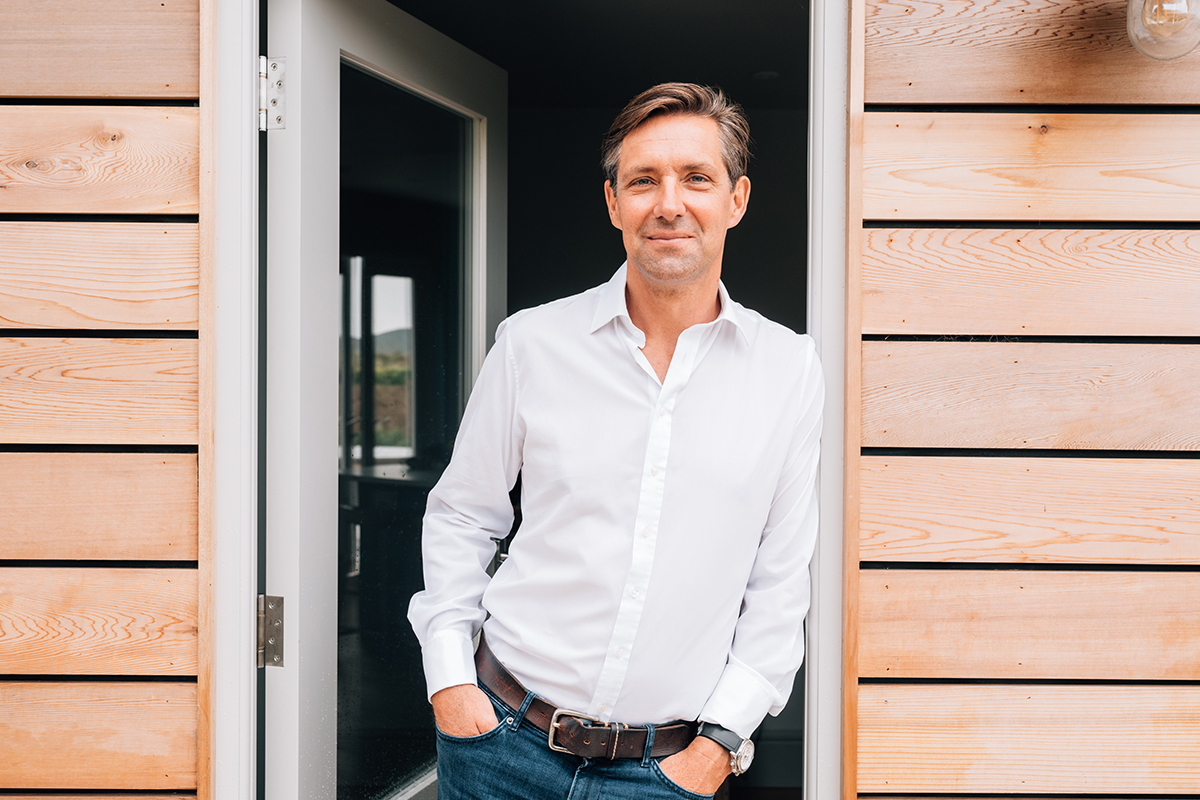 man leaning against door frame