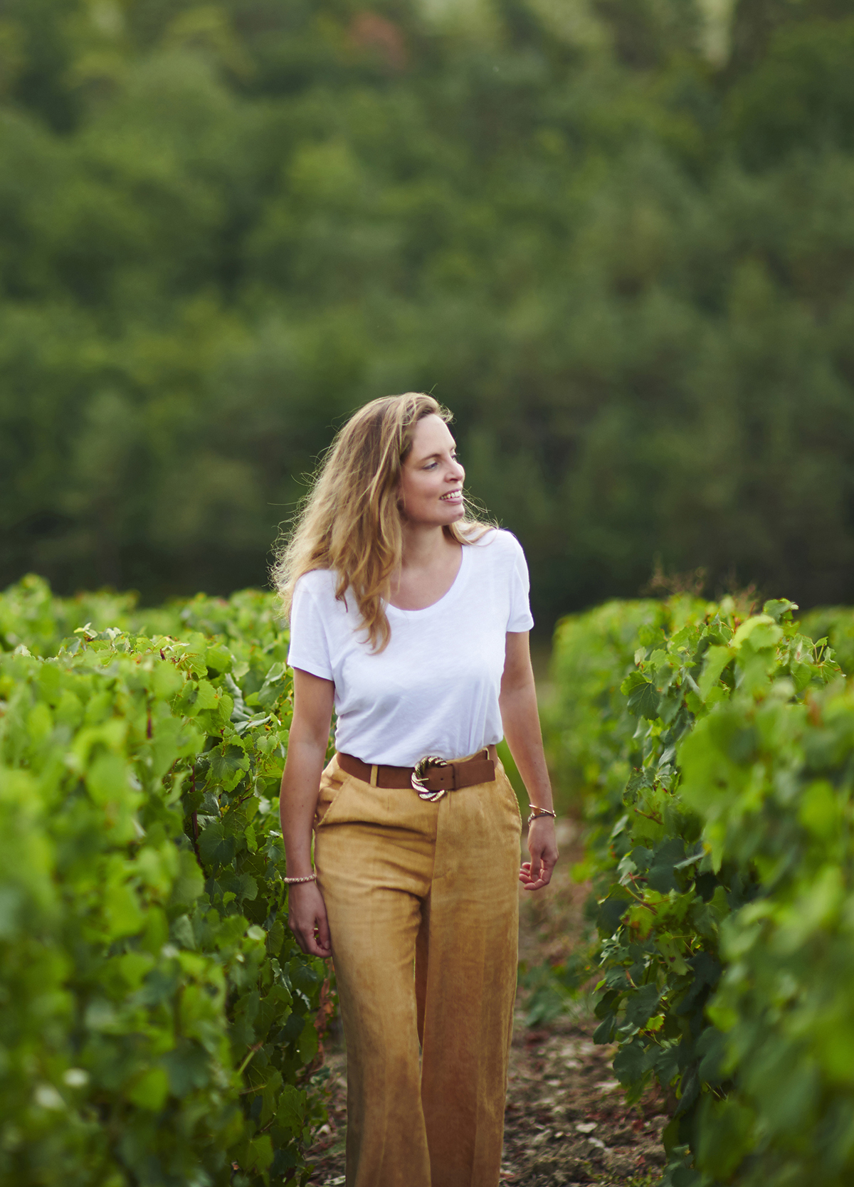 woman walking through vineyards