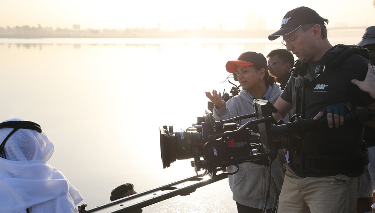 film crew working on a lake at dawn