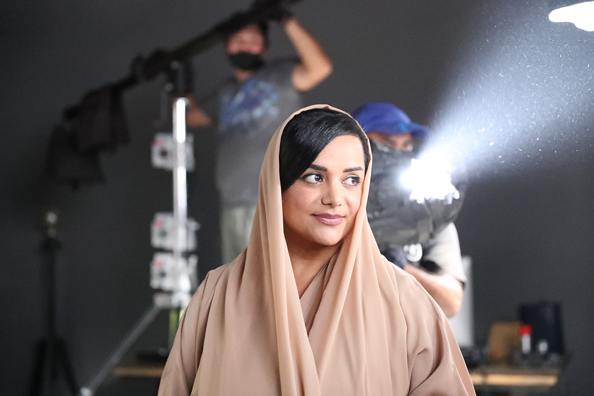 Nayla Al Khaja wearing a pink head cover 