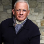 Pascal Raffy wearing a watch and blue jacket with a blue scarf and turtle neck