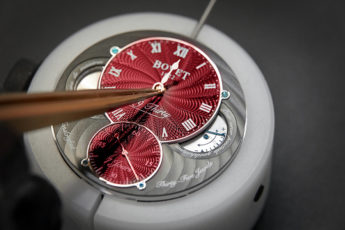 a red watch dial being made