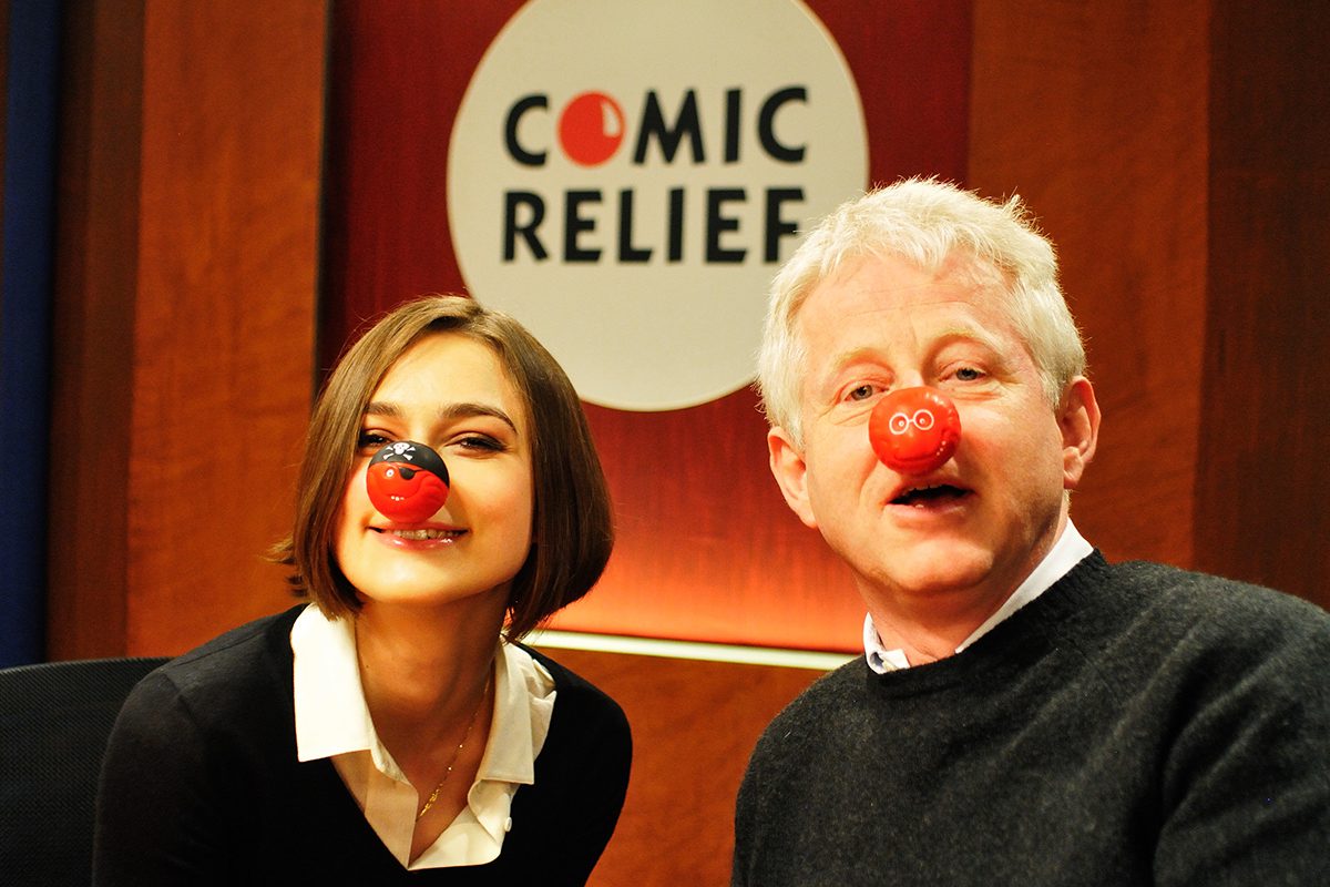 Richard Curtis and Keira Knightley wearing red noses