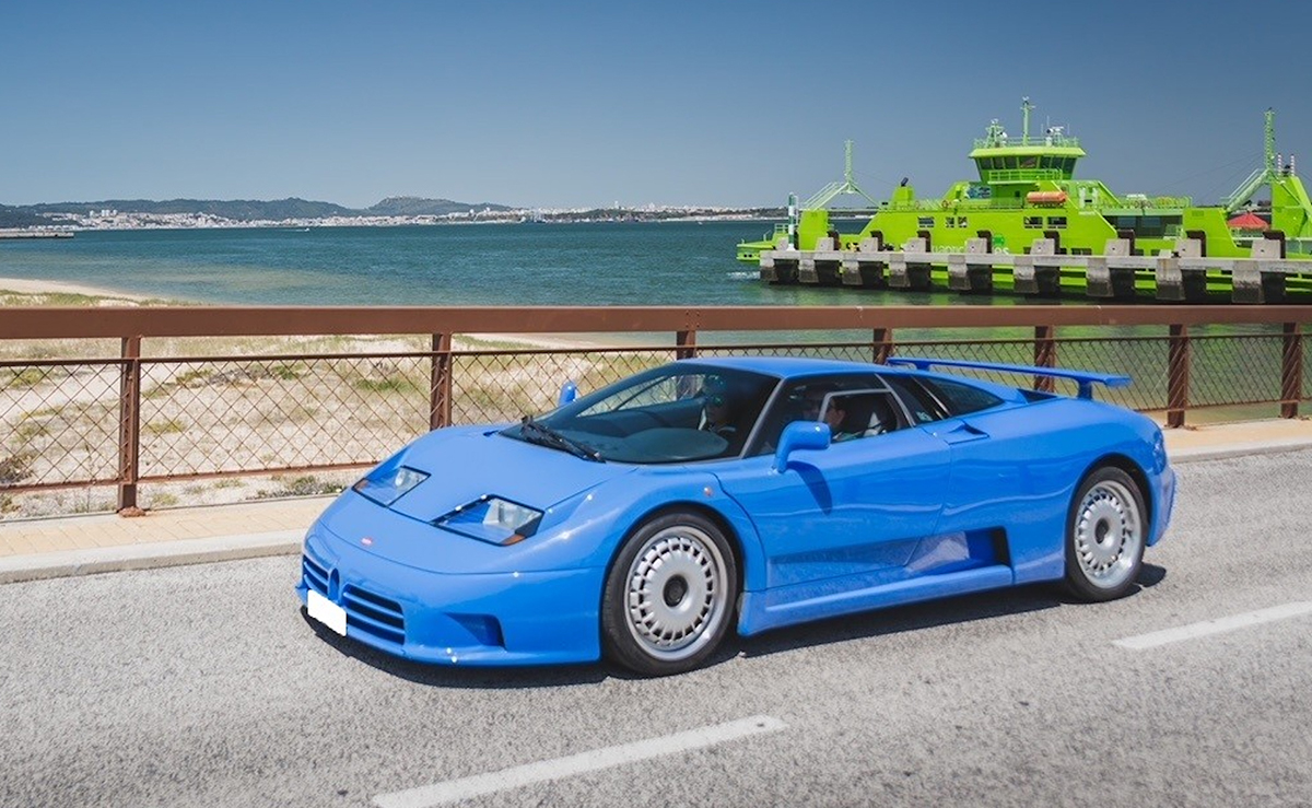 A blue Bugatti by the sea