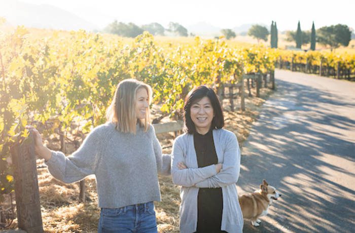 Two women standing in a vineyard