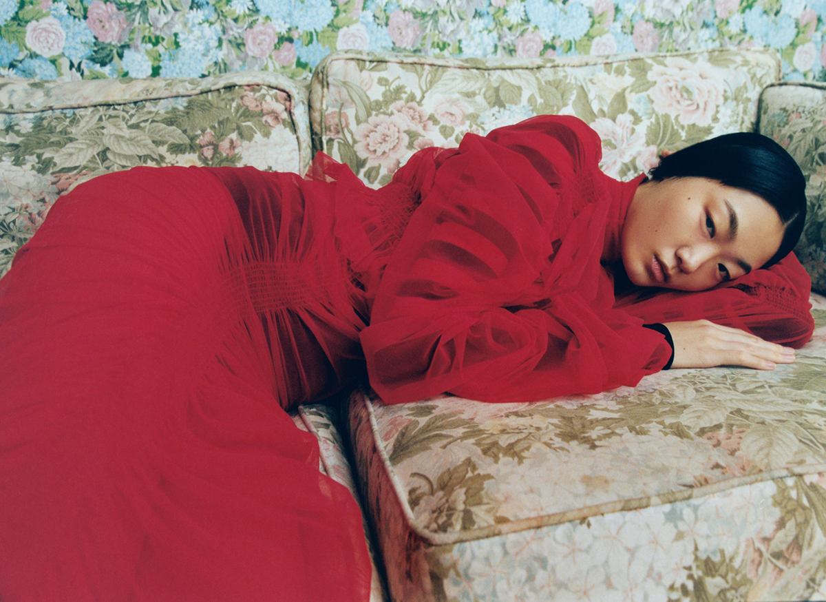 woman lying on sofa in red dress
