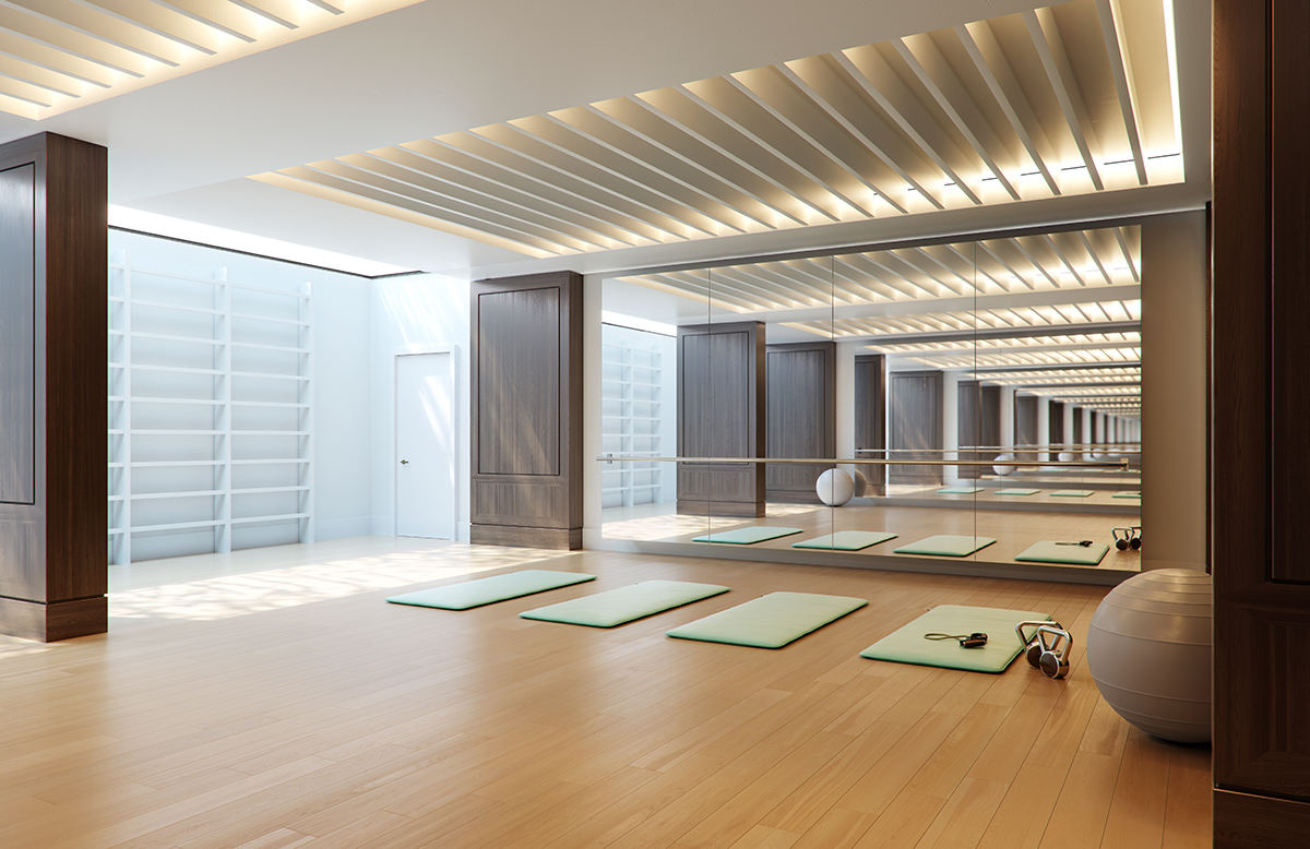 A yoga studio with green mats and a silver ball