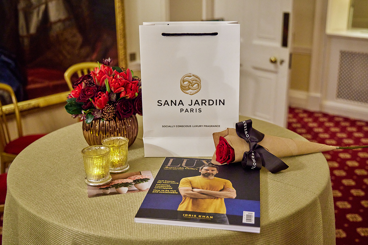 A bag, flowers and magazine on a table
