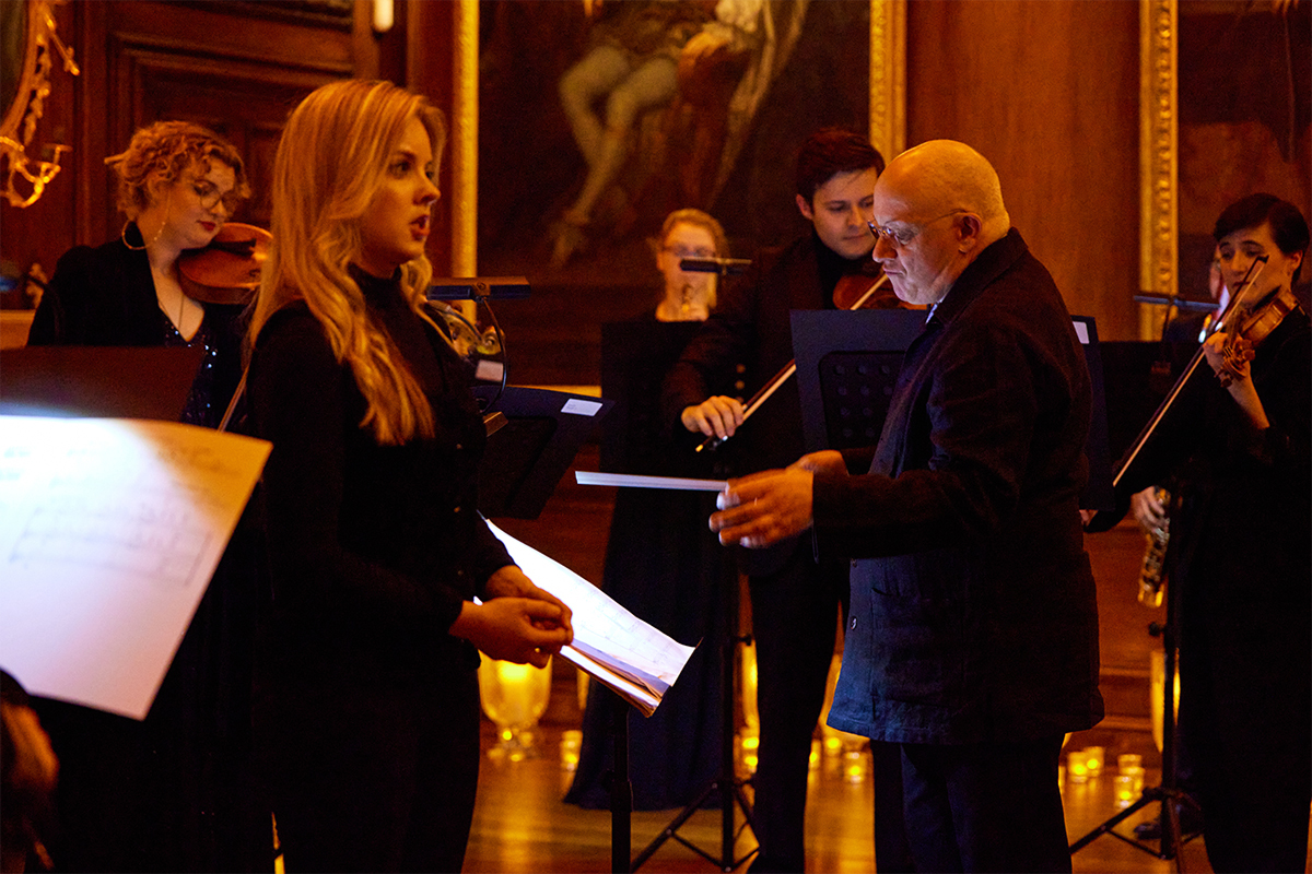 A blonde woman singing in a choir