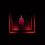 A woman in a dark room with red lights