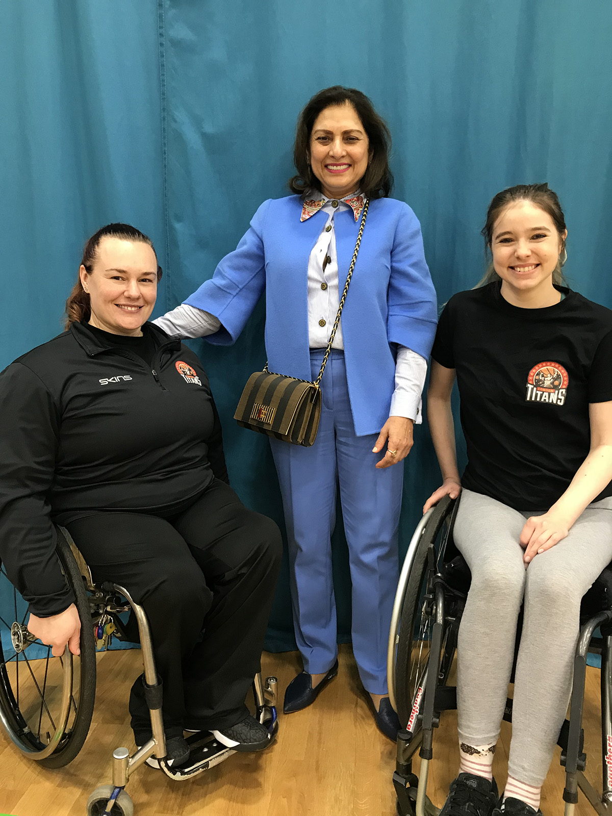 Anita Choudhrie with two girls in wheelchairs