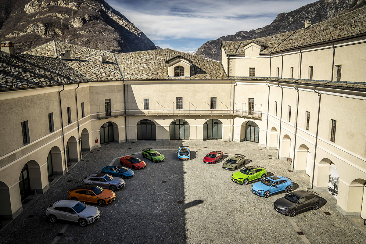 Lamborghinis parked in a semi circle inside a fort