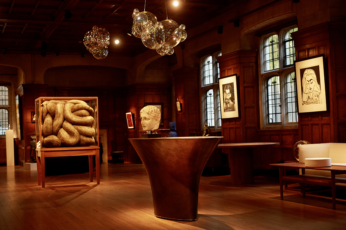 A wooden room with art on the walls