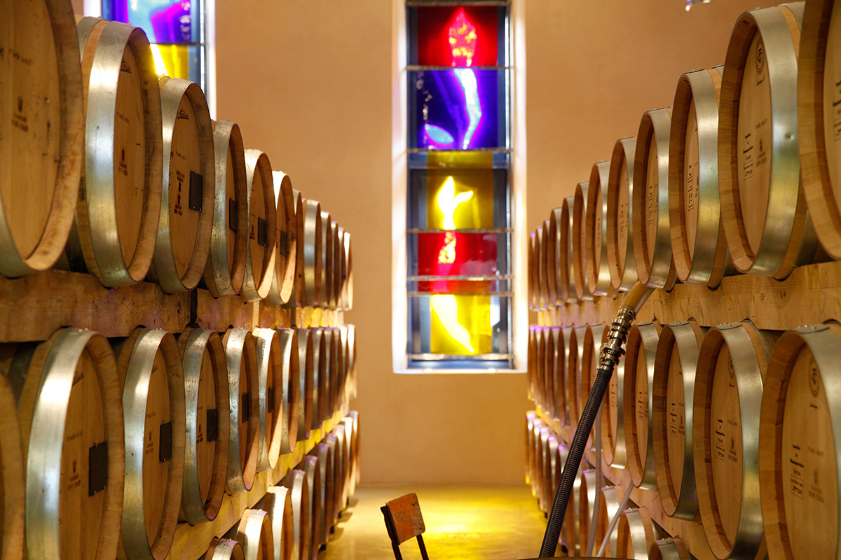 Oak barrels in a room with coloured lights on the walls