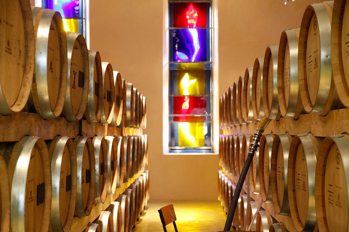 Oak barrels in a room with coloured lights on the walls