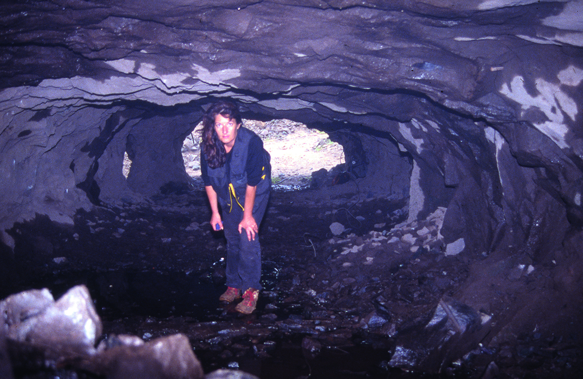 A woman standing in a cave
