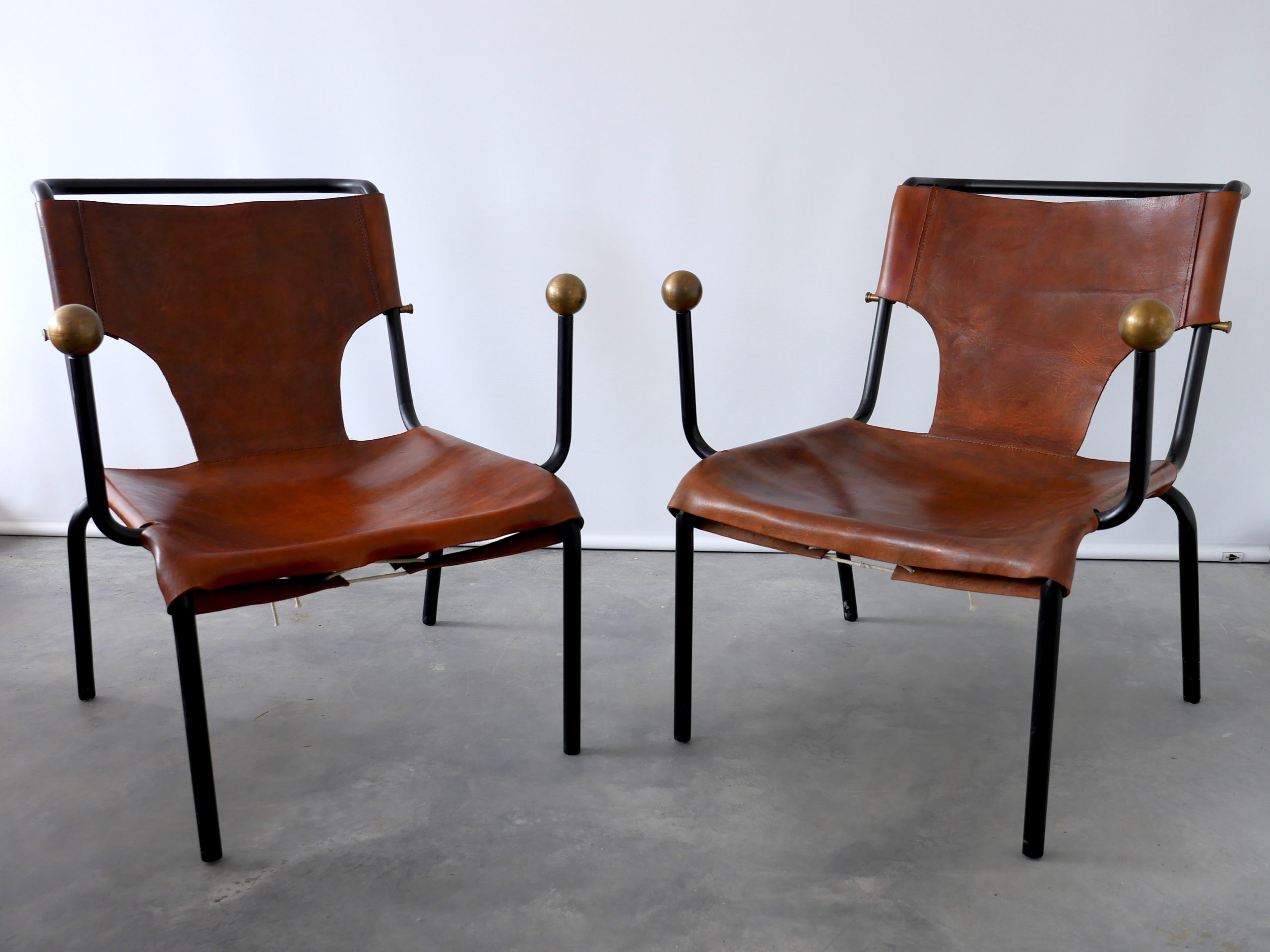 Two brown leather chairs