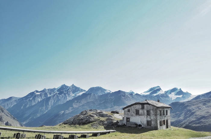 mountains and an alpine lodge on the grass