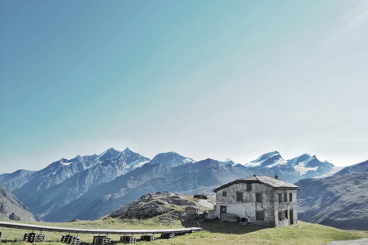 mountains and an alpine lodge on the grass