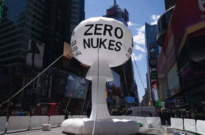 An inflatable white structure that says 'Zero Nukes' in Times Square