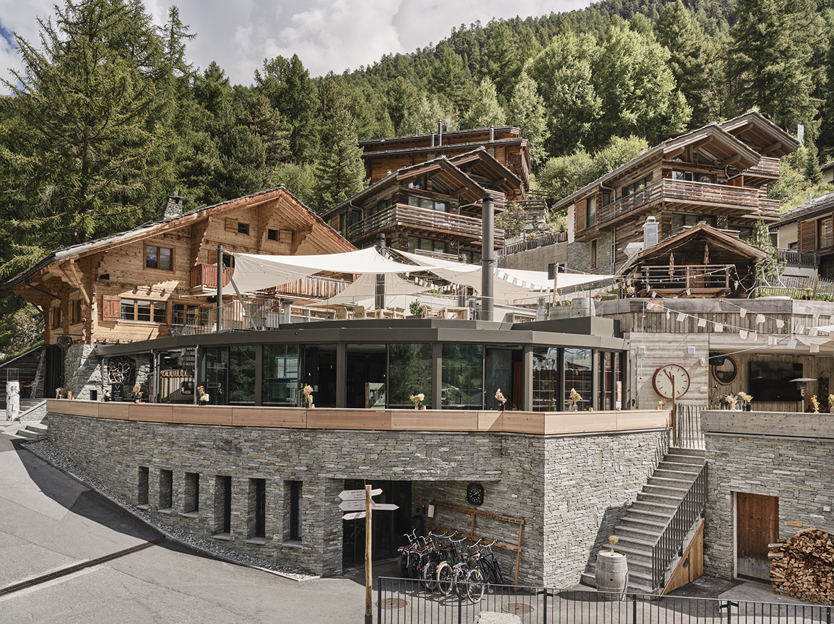 A hotel made of stone and wood in a forest
