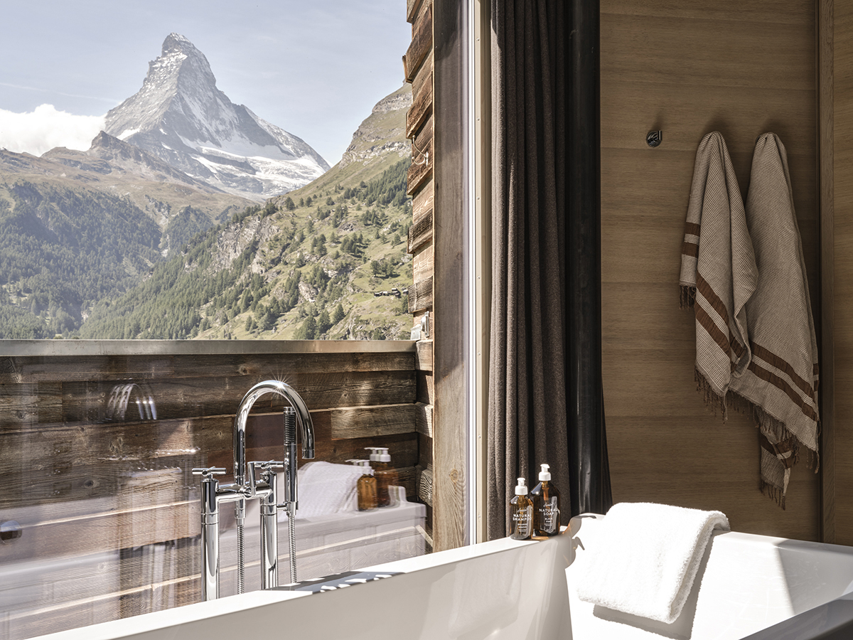 A bath with a view of the Matterhorn outside the window